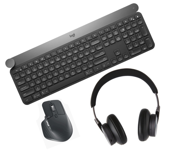 An image showing a black wireless keyboard, a wireless mouse, and a pair of over-ear headphones, representing essential computer accessories for productivity and communication.