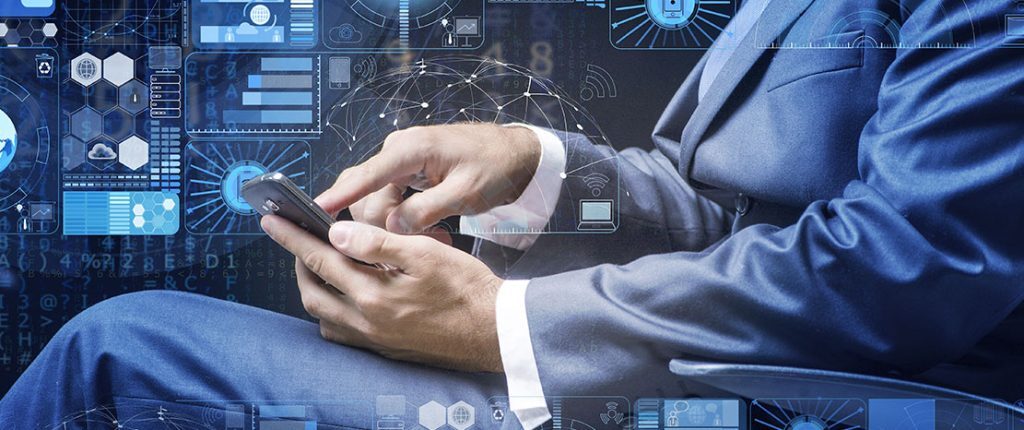 A man in a blue suit sits while using a smartphone, surrounded by digital graphics of data charts, network icons, and futuristic interfaces. The image represents technology, connectivity, and mobile data management.