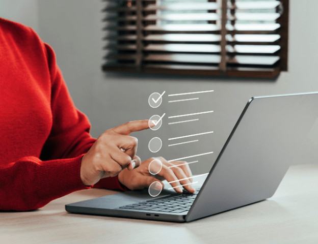 A person working on a laptop with a checklist of completed tasks appearing above the screen,  representing  cloud migration process