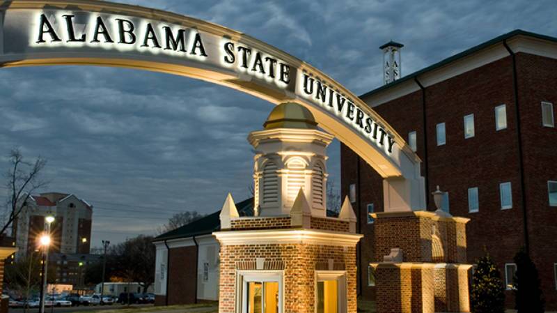 An illuminated entrance archway at Alabama State University, featuring the university’s name in bold letters.