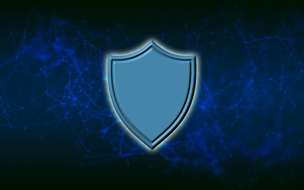 A blue shield icon centered against a dark background with glowing blue network lines and nodes, representing digital security or protection.