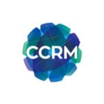 The image shows the logo of CCRM, featuring the letters “CCRM” in white centered over a geometric circular design composed of overlapping blue and green translucent shapes with dotted connecting lines.