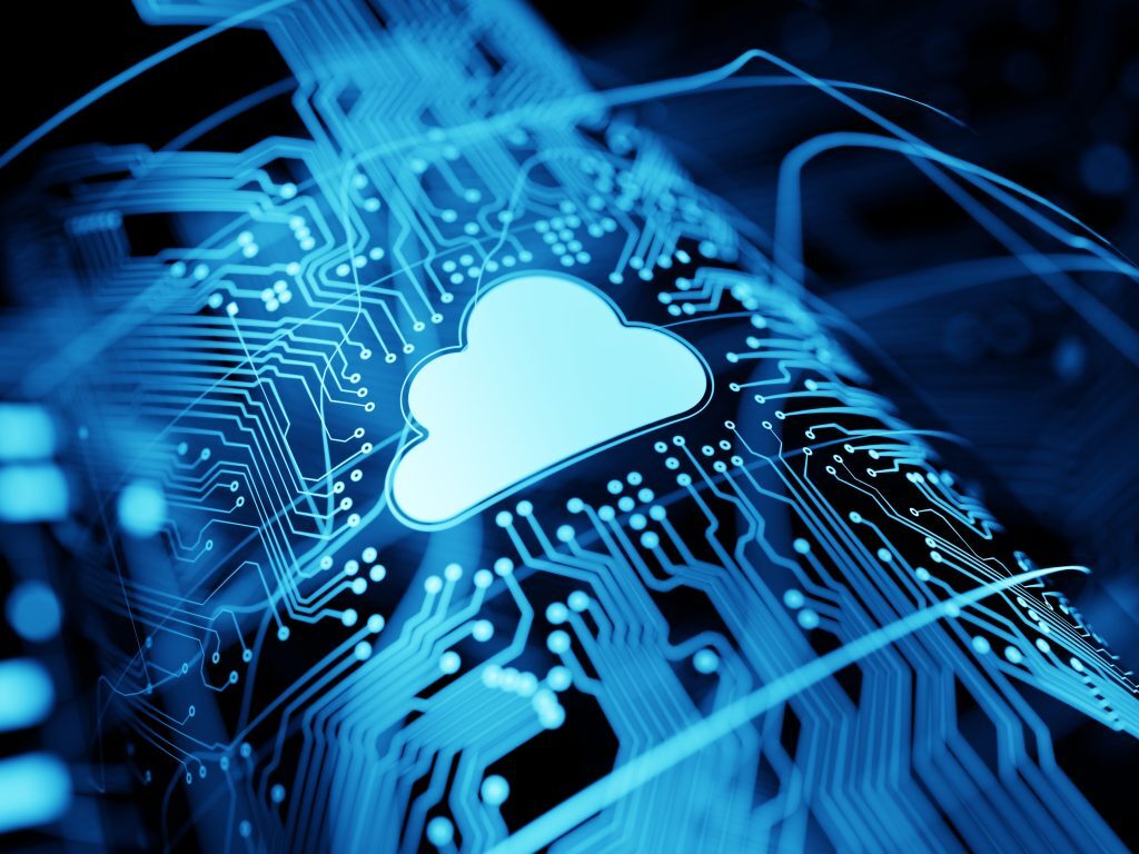 A glowing cloud icon sits at the center of a blue digital circuit board, symbolizing cloud computing, data storage, and modern digital connectivity.