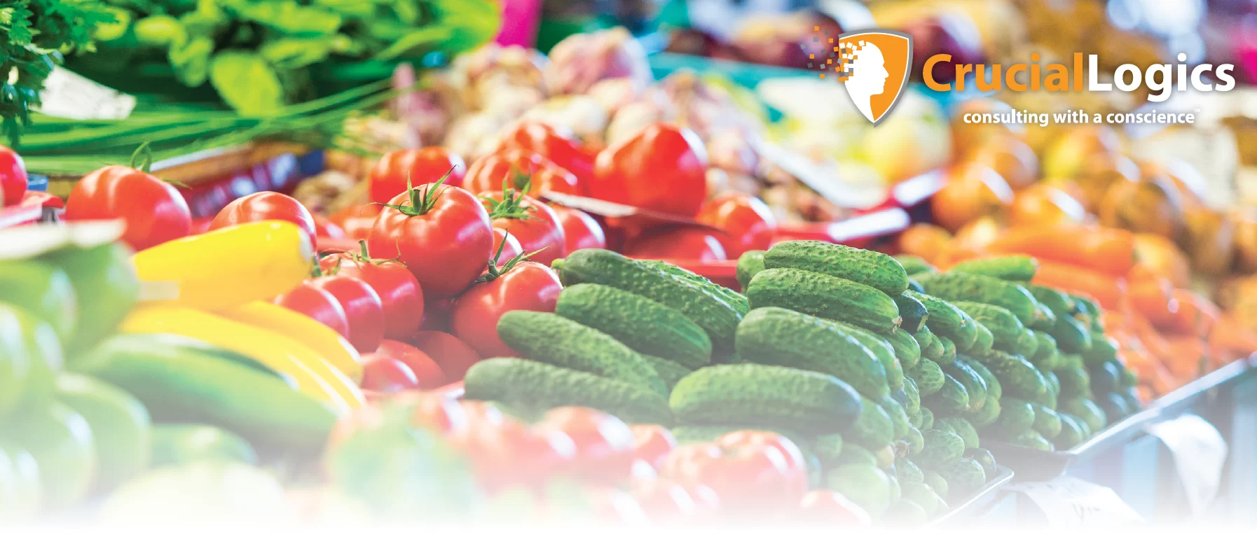 An image of a colorful market display featuring fresh vegetables including cucumbers, tomatoes, bell peppers, and leafy greens; the CrucialLogics logo with the tagline consulting with a conscience appears in the upper right corner.